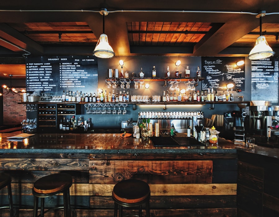 The warm, dimly lit Ironwood taproom with a long bar, draught lines and pendant lights