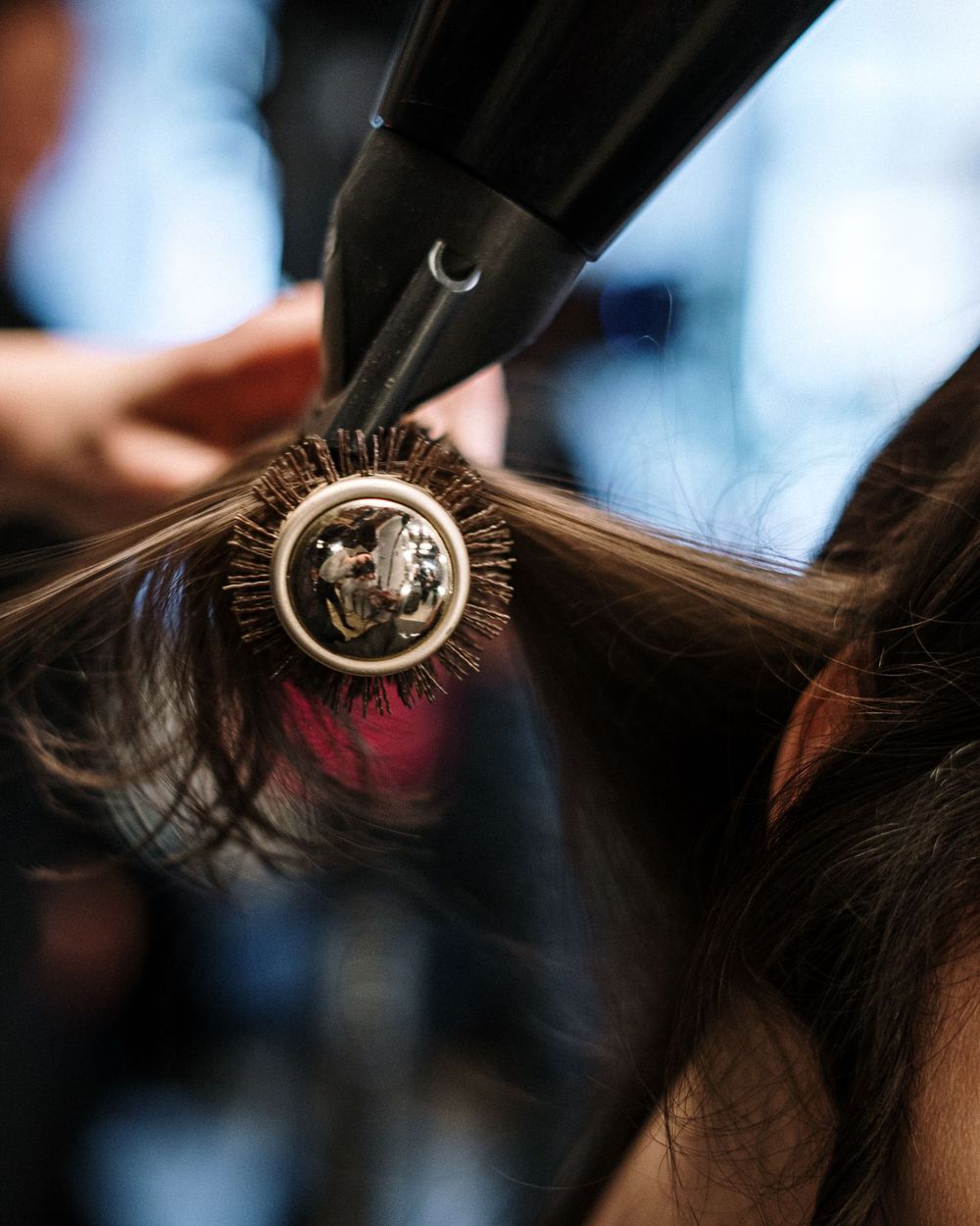 A round brush and dryer mid-blowout