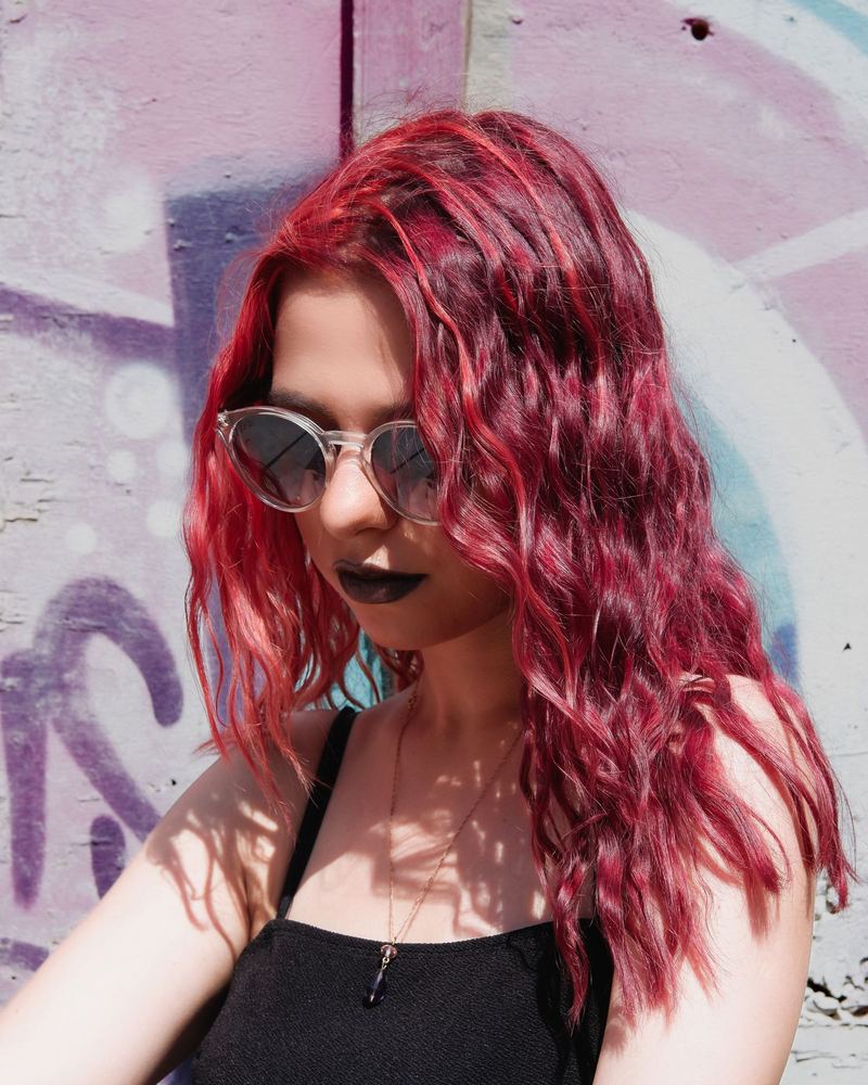 Deep red waves against a graffiti wall