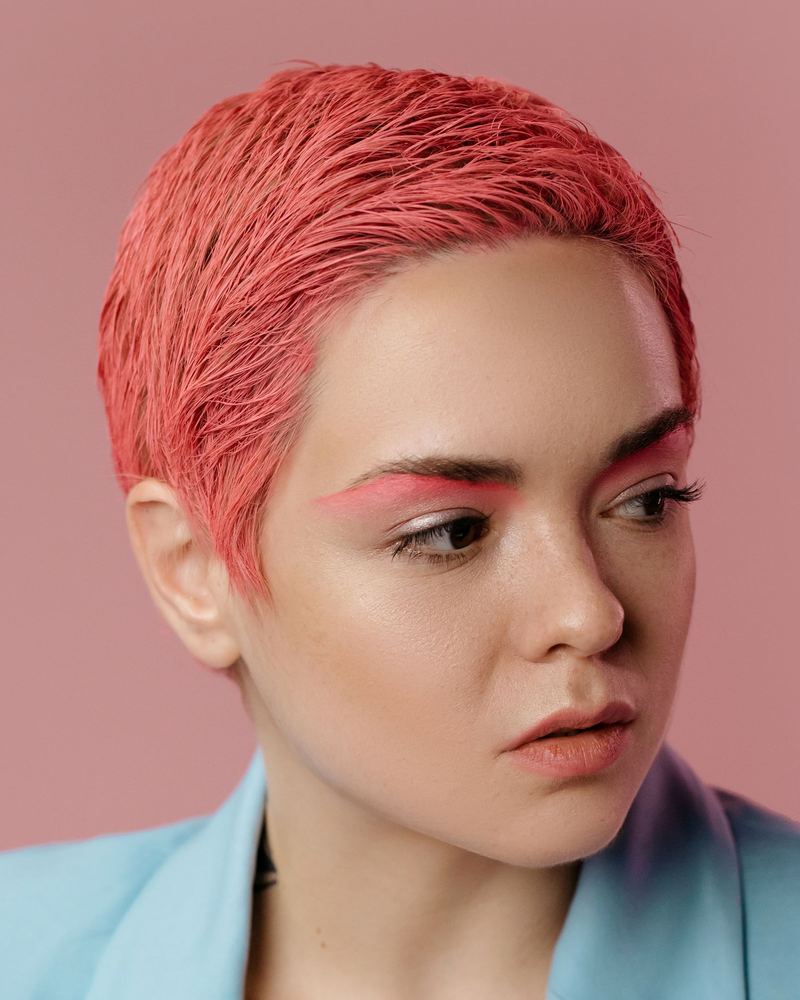 Coral pink pixie cut in studio light