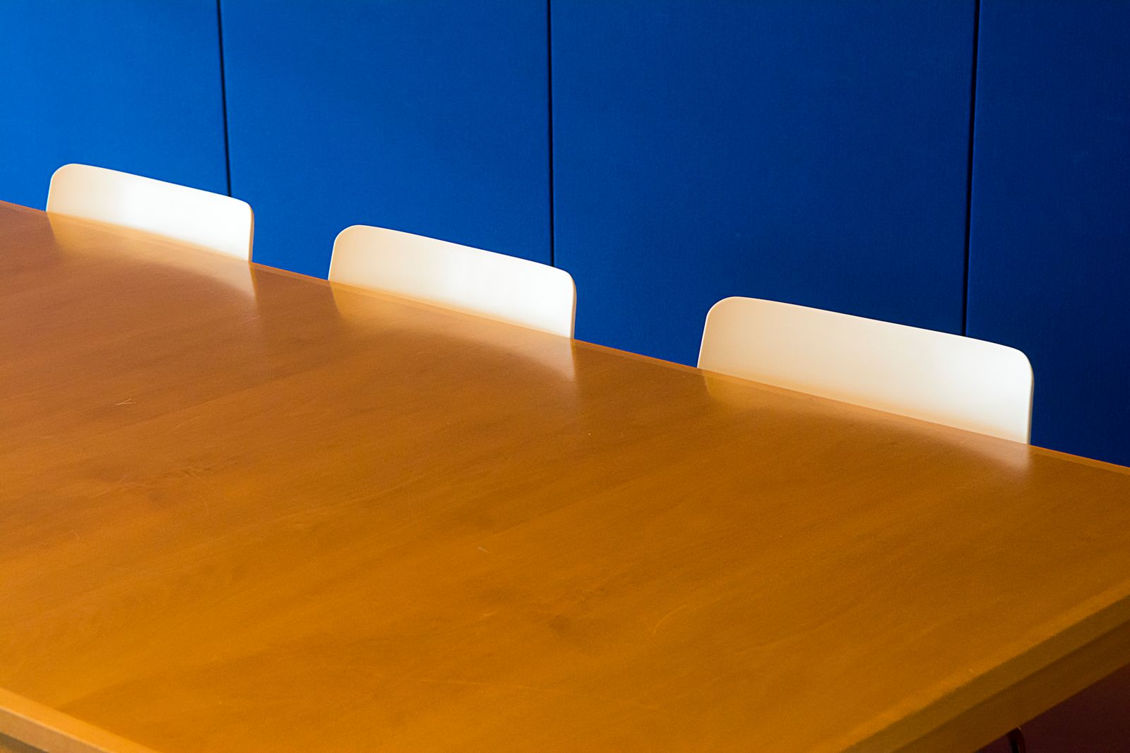 Meeting table with empty chairs