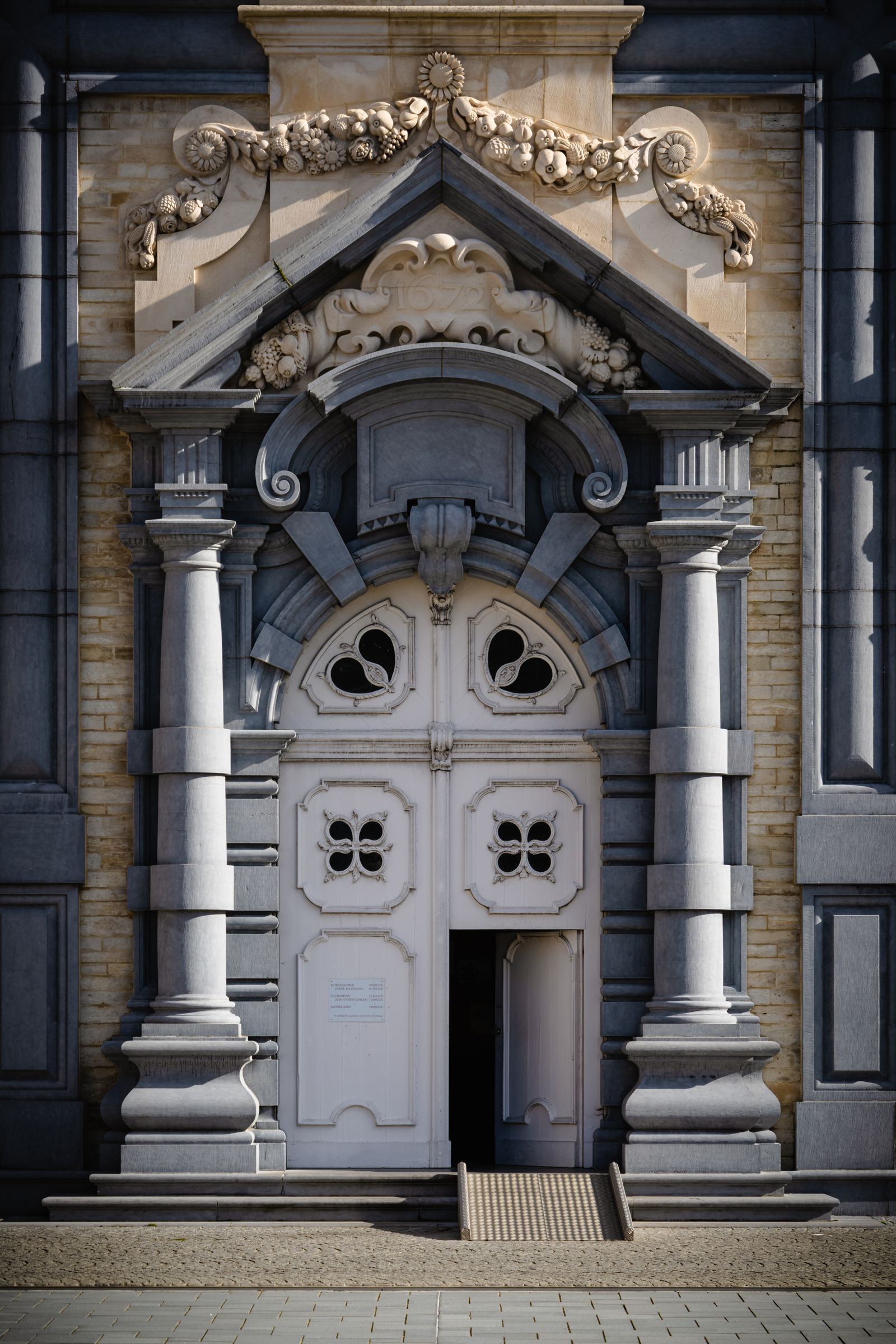 Baroque stone portal with an arched pediment