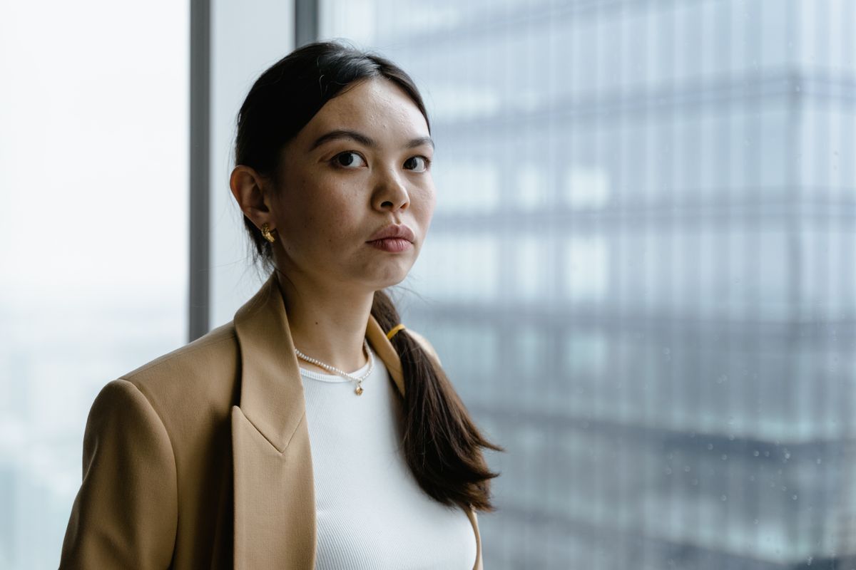 Ana Vidas photographed beside a glass office tower