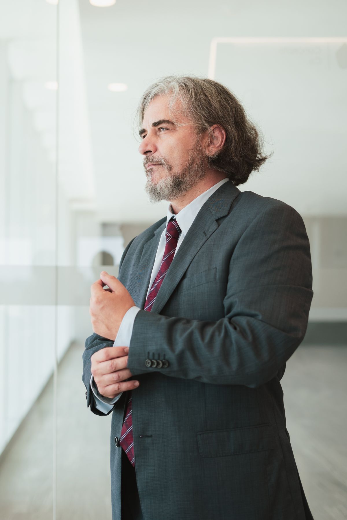 Marko Barun in a grey suit by the office window
