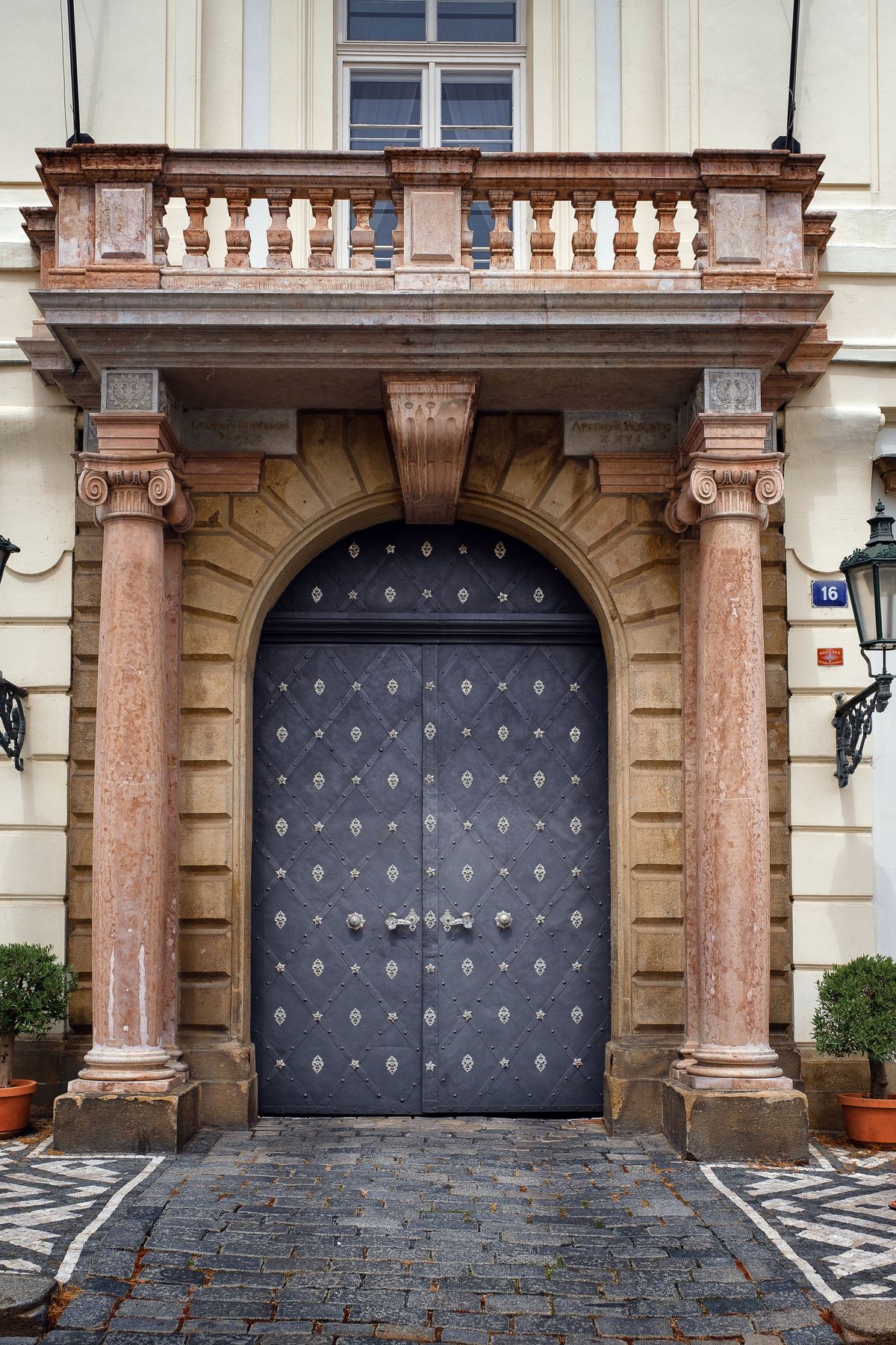 Baroque entrance portal with a studded blue door