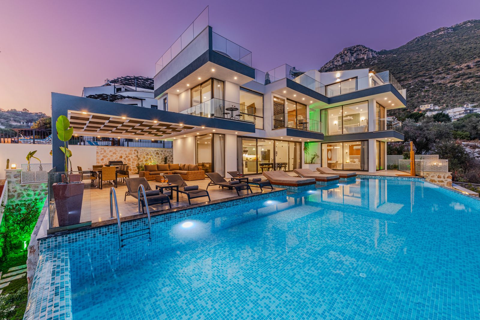 Modern villa with an infinity pool at dusk