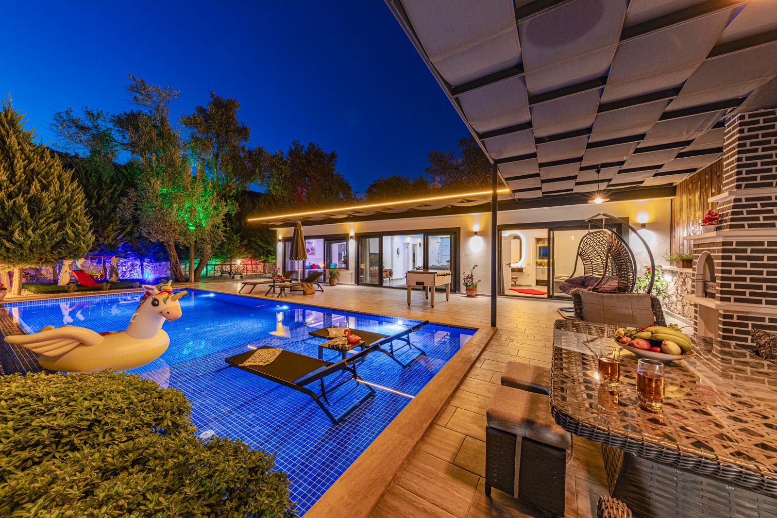 Villa with a lit pool in the evening, Split