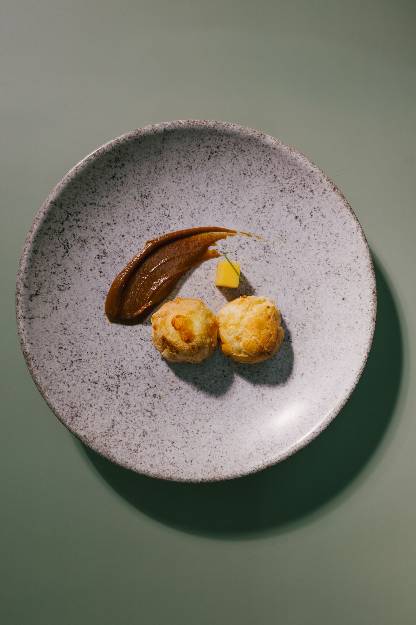Plated dish on a stone plate over a sage cloth