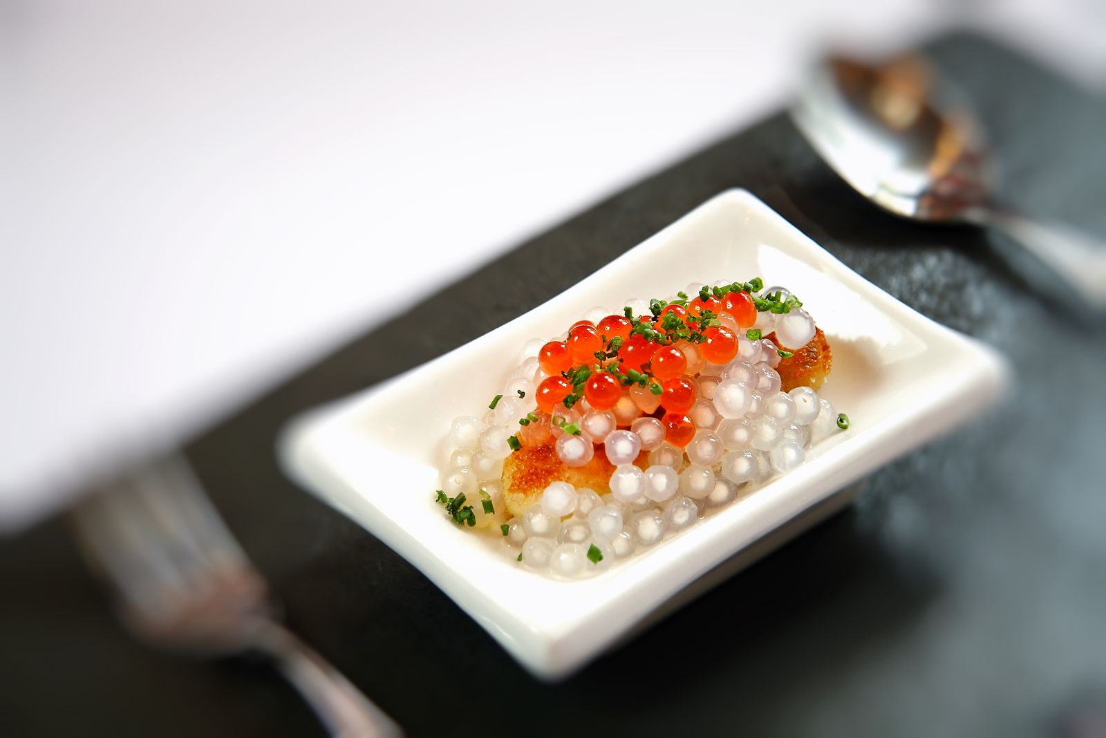 Spoonful of roe over a creamy starter