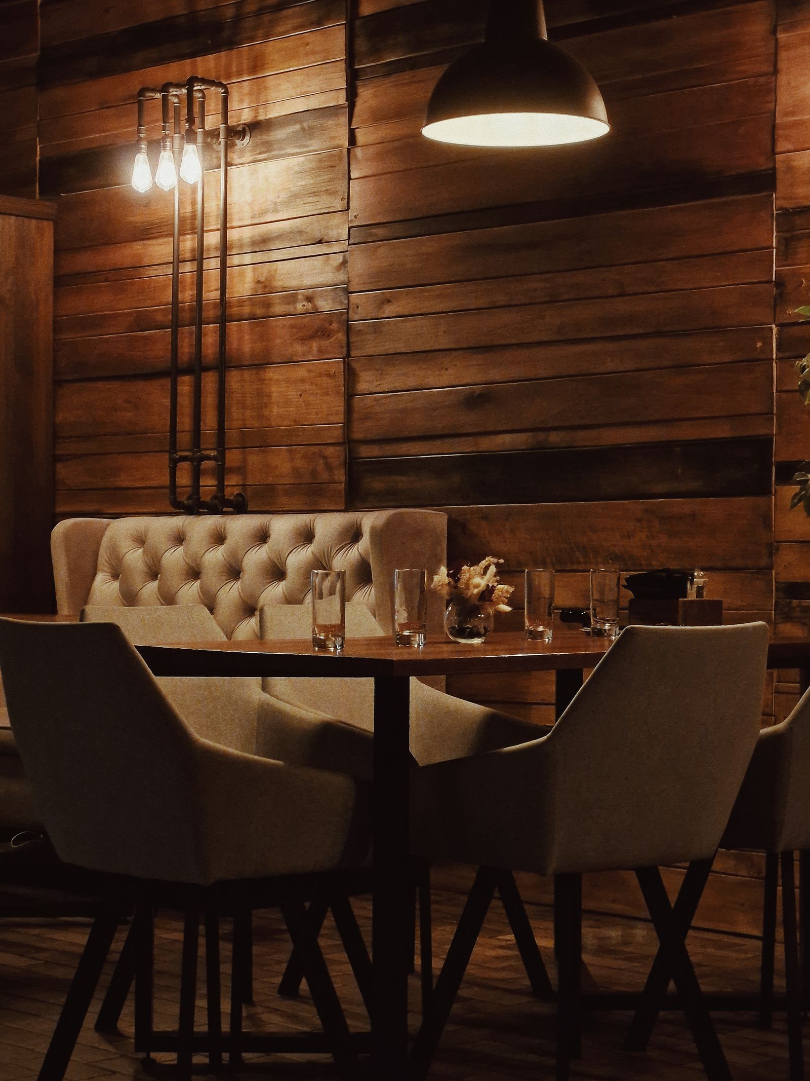 Dark banquette seating in the dining room at night