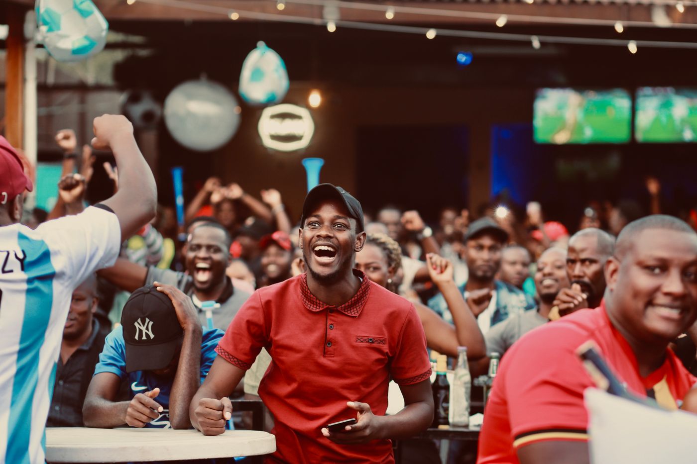 Crowd in the bar cheering during a match