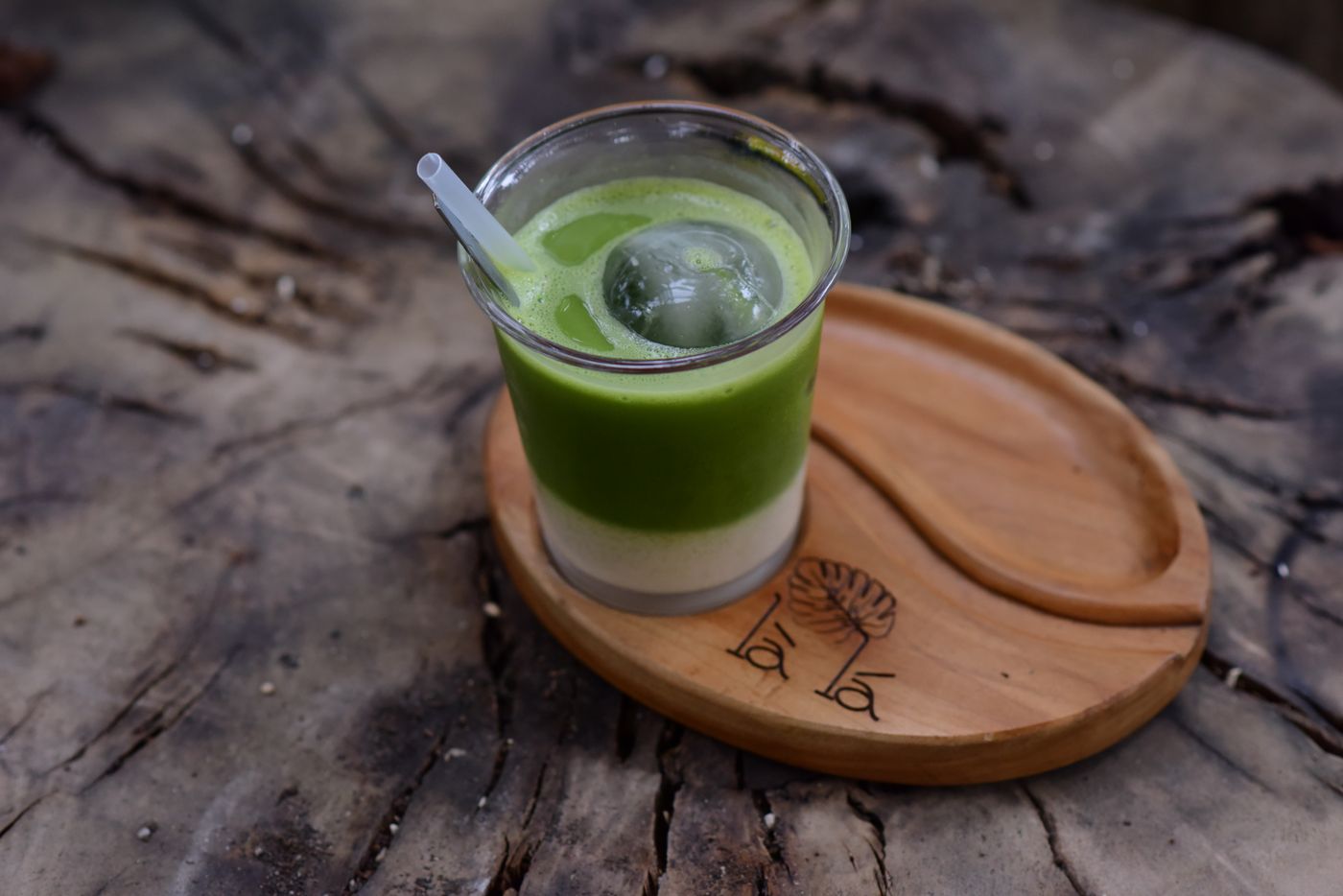 Iced matcha latte on a wooden board