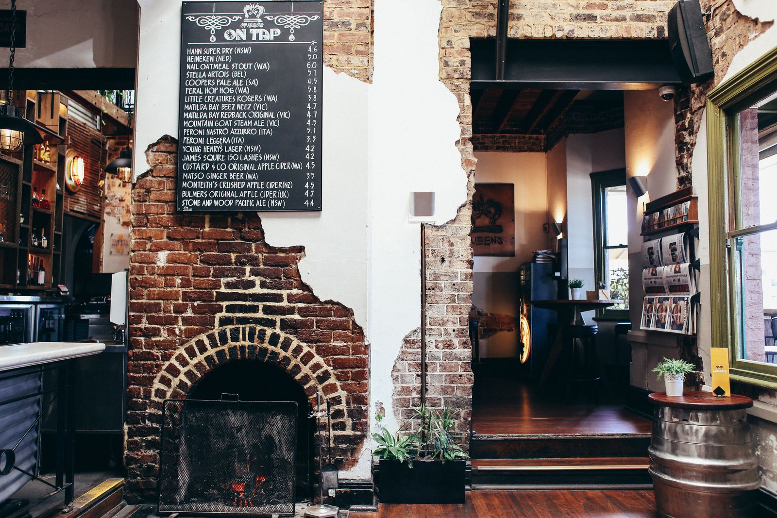 Inside Potter: exposed brick, a fireplace and the chalkboard above the bar