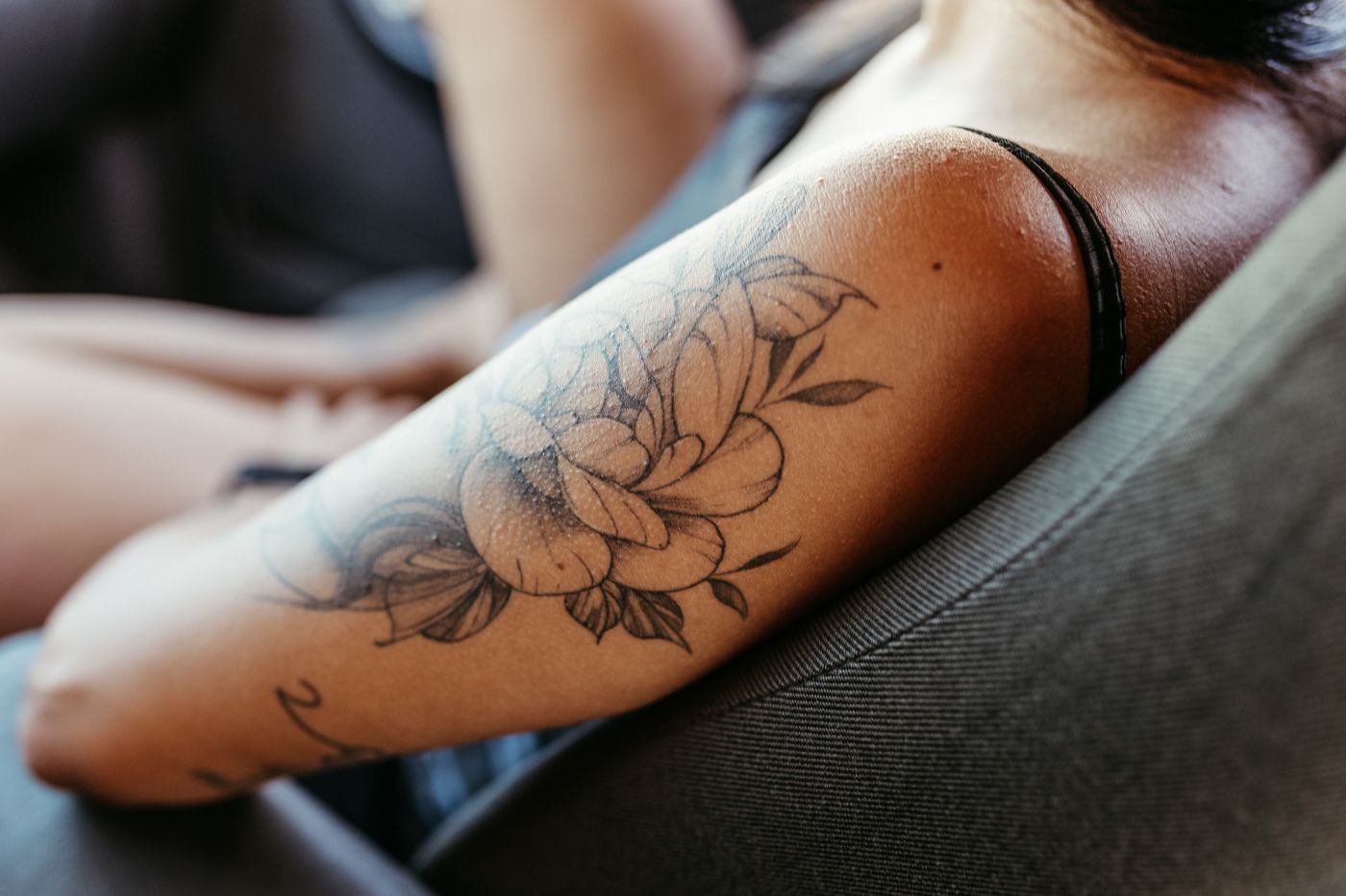 Fine line floral tattoo on a forearm