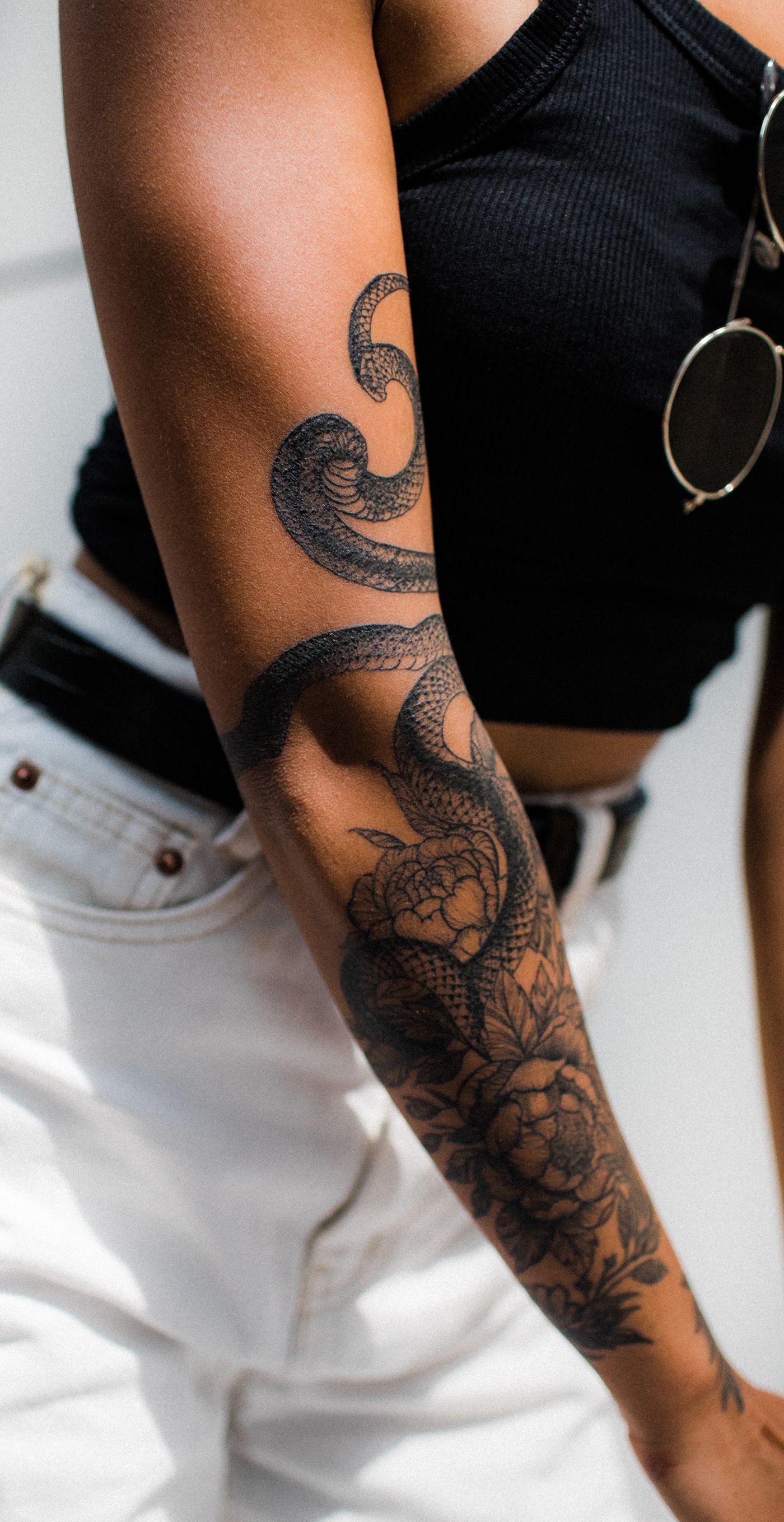 Delicate line tattoo along an upper arm